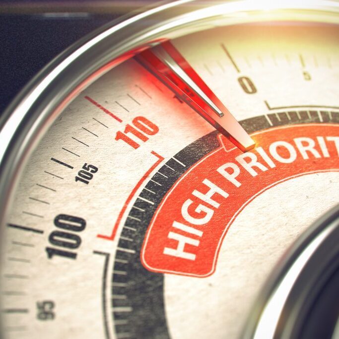 Conceptual Illustration of a Gauge with Red Needle Pointing to Maximum of High Priority. Horizontal image. 3D Render.